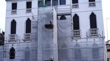 Scaffolding attached to facade of historical white building video
