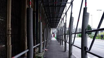 Scaffolding at building construction protecting sidewalk video