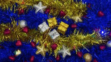Christmas tree decorations lie on changing color garlands video