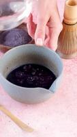 Step by step tutorial making blue matcha tea. Step two , adding hot water and whisk video
