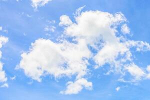 A blue sky with white clouds and a few clouds photo