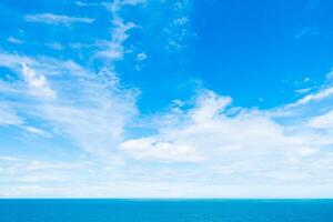 A blue sky with clouds over the ocean photo