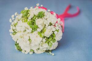 A bouquet of white flowers on a blue background photo