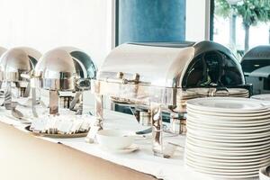A buffet table with silver plates and silver dishes photo