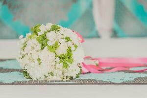 A bouquet of white flowers on a bed photo