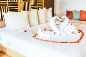 A bed with two swans made out of towels photo