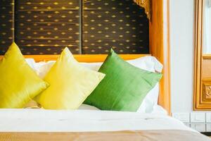 A bed with pillows and a mirror photo