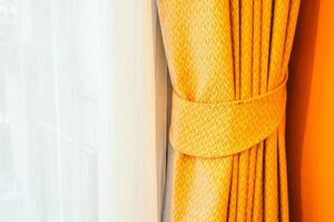 A close up of a curtain with a yellow pattern photo