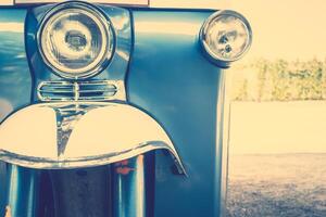 A close up of a vintage car with a front light photo