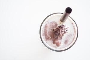 A chocolate milkshake with a straw in it photo