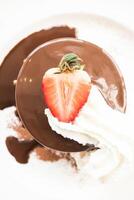 A chocolate dessert with a strawberry on top photo