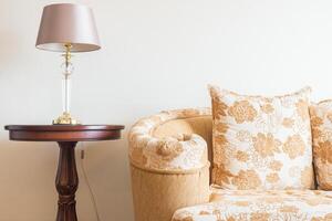 A couch with a lamp and a table photo