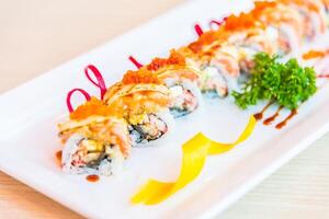 A long sushi roll with shrimp and vegetables photo
