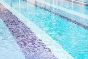 A long pool with blue water and white lines photo
