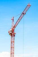 A large red crane on top of a building photo