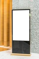 A large blank screen in front of a wall photo