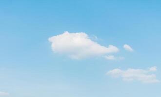 A large field with a large white cloud in the sky photo