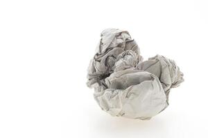 A pile of crumpled paper on a white surface photo