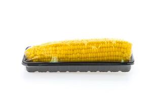 A plastic container with corn on a white background photo