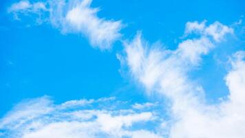 A plane flying in the sky with some clouds photo