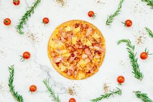 A pizza with ham and tomatoes on a white background photo