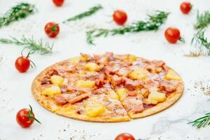 A pizza with ham and pineapple on a white background photo