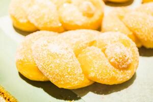 A plate of donuts with powdered sugar on them photo