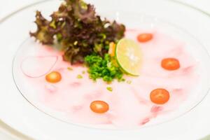 A plate of food with a garnish of tomatoes and a garnish of lettuce photo