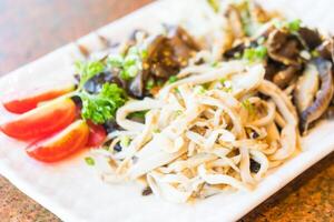A plate of noodles with vegetables and tomatoes photo