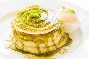 A plate topped with a green cake and ice cream photo