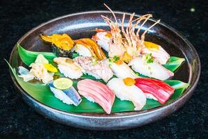 A plate of sushi with various types of seafood photo