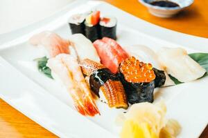 A plate of sushi with various types of seafood photo