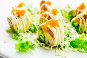A plate topped with sushi and vegetables photo