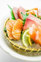 A plate of sushi with a slice of lemon photo