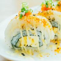 A plate of sushi with cheese and green onions photo