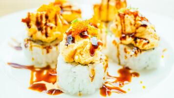 A plate of sushi with sauce and orange slices photo