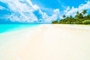 A sandy beach with white sand and blue sky photo