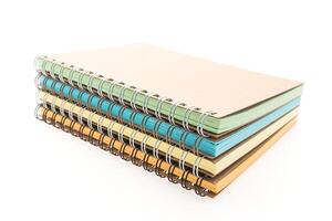 A stack of spiral notebooks on a white background photo