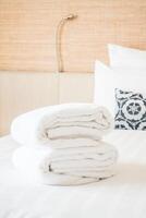 A stack of white towels on a bed photo