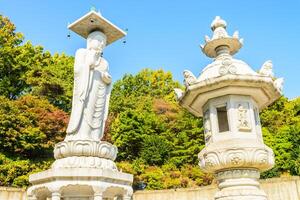 A statue of a buddha sitting on a pedestal photo