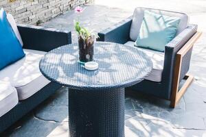 A table with a vase of flowers photo