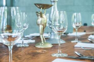 A table with empty wine glasses and silverware photo