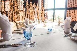A table with a glass of wine and a napkin photo
