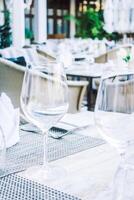 A table with a glass of wine and a plate of food photo