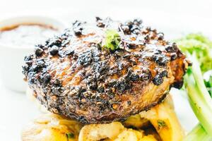 A steak with a side of potatoes and broccoli photo