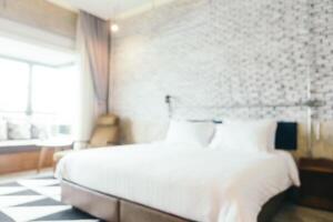 A white bed with a black and white checkered floor photo