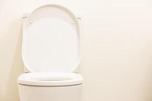 A white toilet with a lid up photo