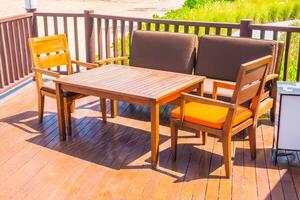 A wooden deck with a table and chairs photo