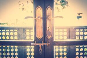 A wooden door with a handle and a window photo