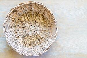 A wicker basket on a wooden table photo